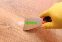 remove adhesive from a hardwood floor